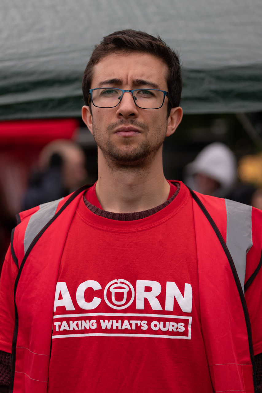 James, a teacher from Manchester, wearing a red 'ACORN' t-shirt