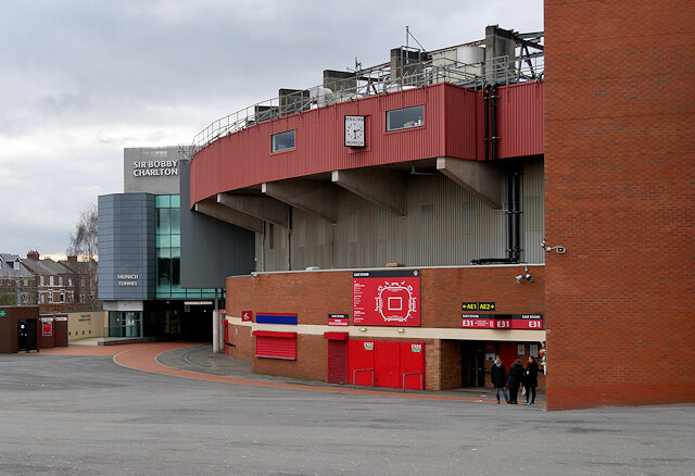 A view of the south east corner of Old Trafford football stadium showing the memorial clock installed in 1960 as a tribute to the victims of the 1958 Munich Air Disaster, and also the tunnel below the South Stand (Sir Bobby Charlton Stand) which was renamed as the "Munich Tunnel".