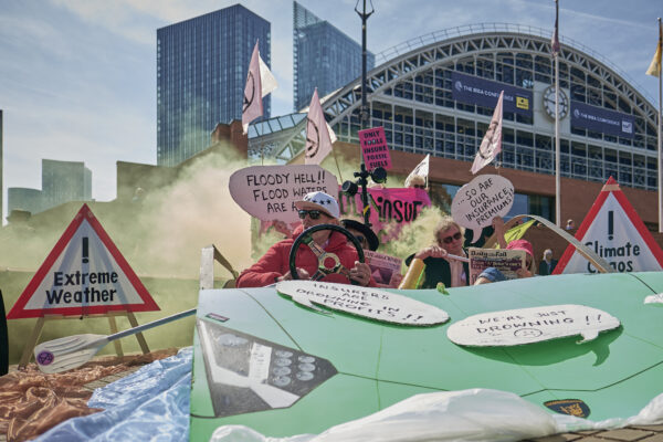 Insurance industry conference in Manchester draws protest against fossil fuels